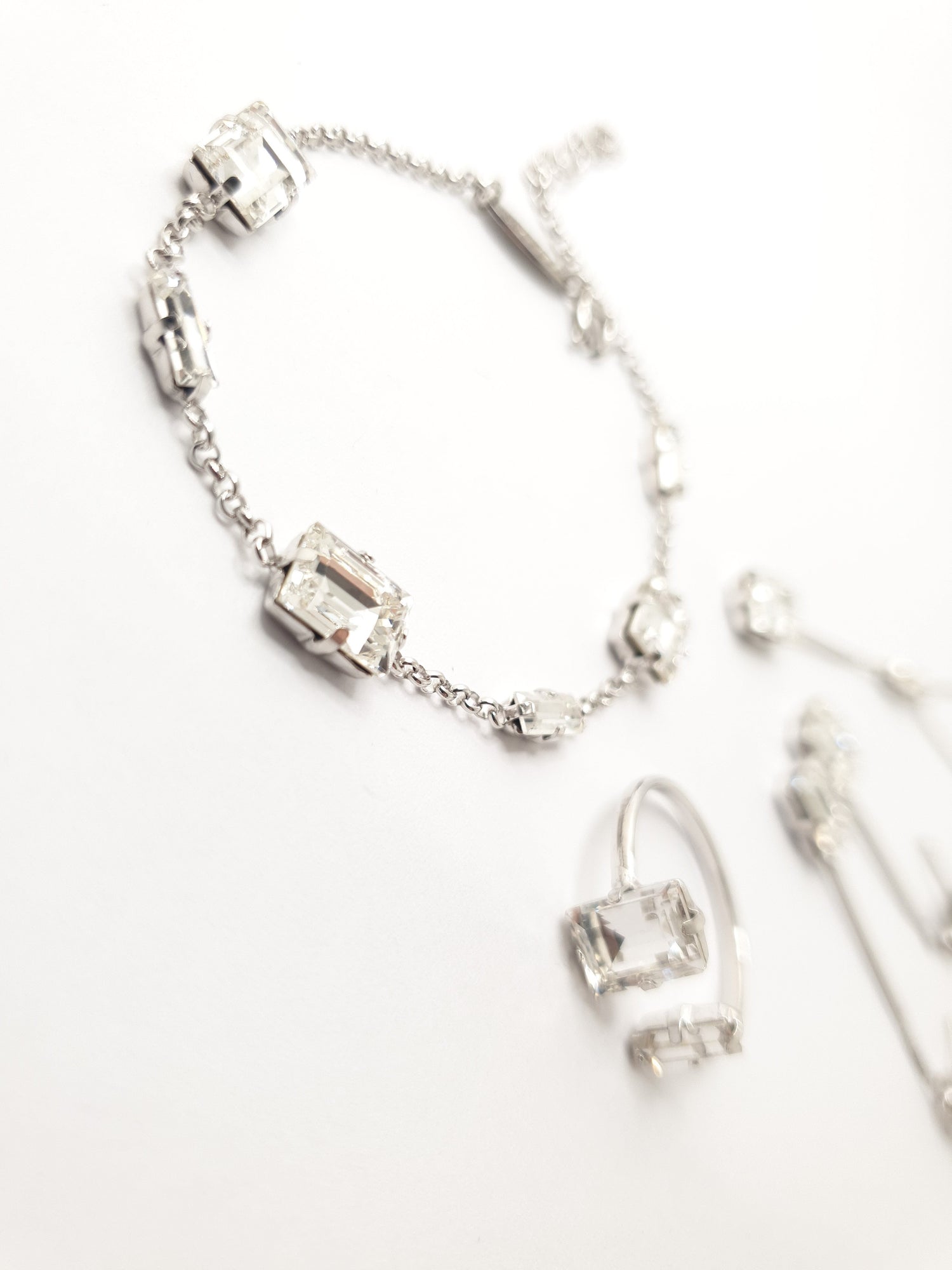 Swarovski Armband aus 925 Silber mit von Hand eingesetzten weißen funkelnden Kristallen, Ring in verstellbarer Größe verziert mit einem weißen großen eckigen Kristall und einem kleinen länglichen weißen Kristall 